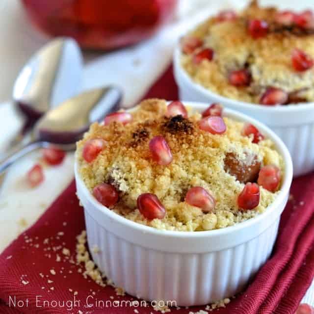Festive Pear and Pomegranate Crumble topped with pomegranate seeds served in individual ramekins