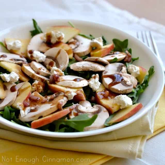 Mushroom, Apple and Goat Cheese Salad with Honey-Balsamic Dressing in a white bowl