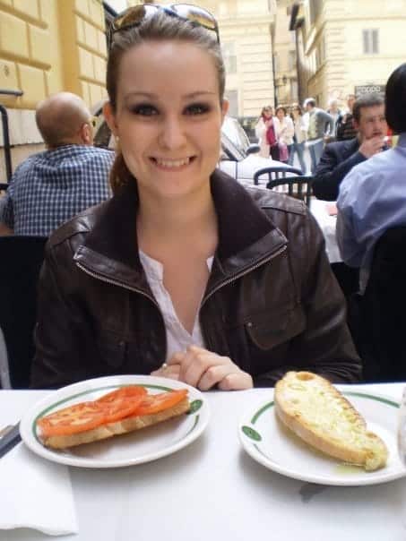 a woman sitting enjoying her bruschetta at an outside eatery in Rome