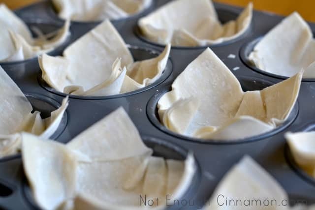 unbaked phyllo cups in a muffins tin, ready to be baked