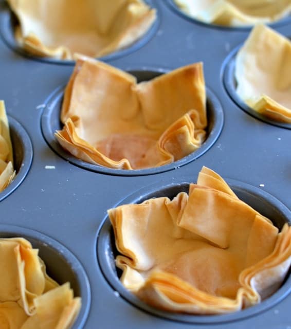 homemade phyllo cups in a muffin tray fresh out of the oven and crispy golden