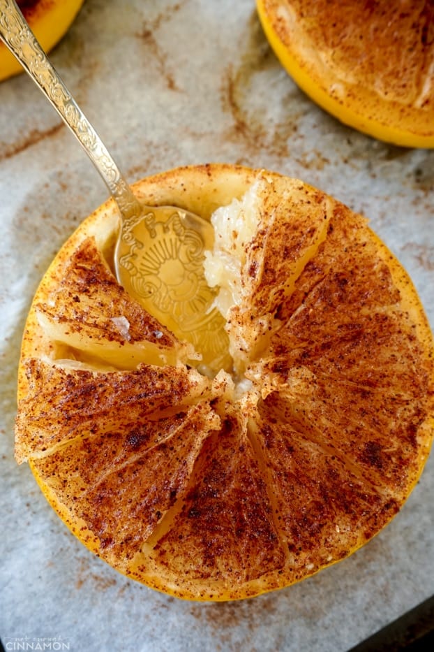 Baked half grapefruit with a golden spoon