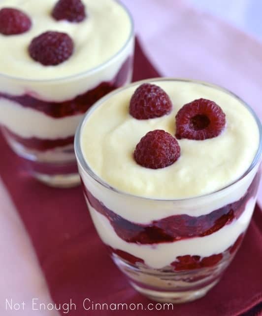  Easy Raspberry Tiramisu served in dessert glasses topped with three fresh raspberries