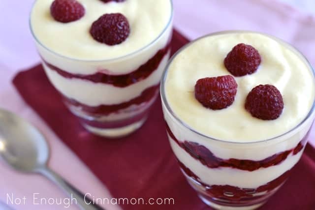  Easy Raspberry Tiramisu served in dessert glasses topped with three fresh raspberries