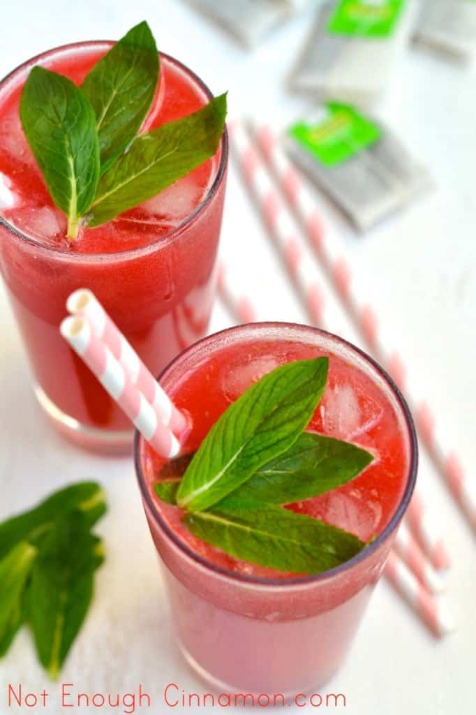 Lime Raspberry Iced Tea served in 2 tall glasses with straws and some fresh mint on top