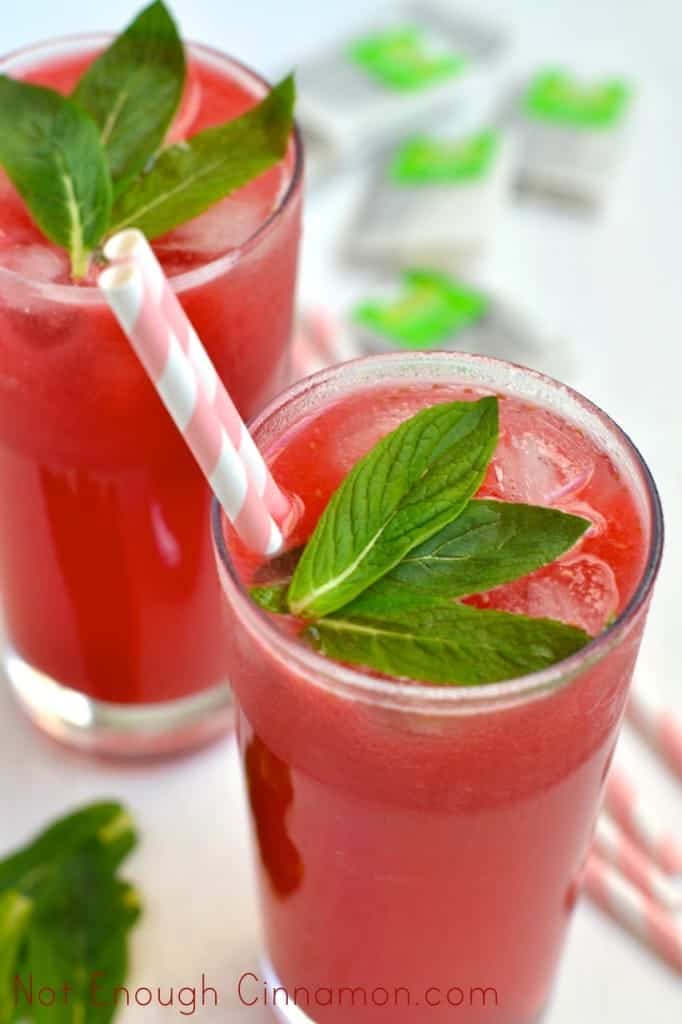 Lime Raspberry Iced Tea served in 2 tall glasses with straws and some fresh mint on top