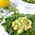 Crab and Avocado Salad served on a bed of arugula in a white bowl
