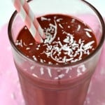 Raspberry Cinnamon Green Smoothie in a tall glass with 2 straws