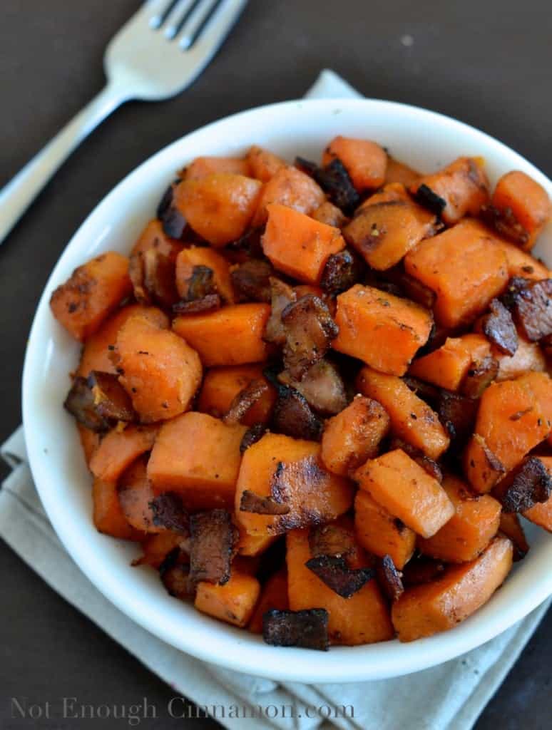 Bacon and Sweet Potato Skillet served in a small white bowl with a lot of crunchy bacon on top