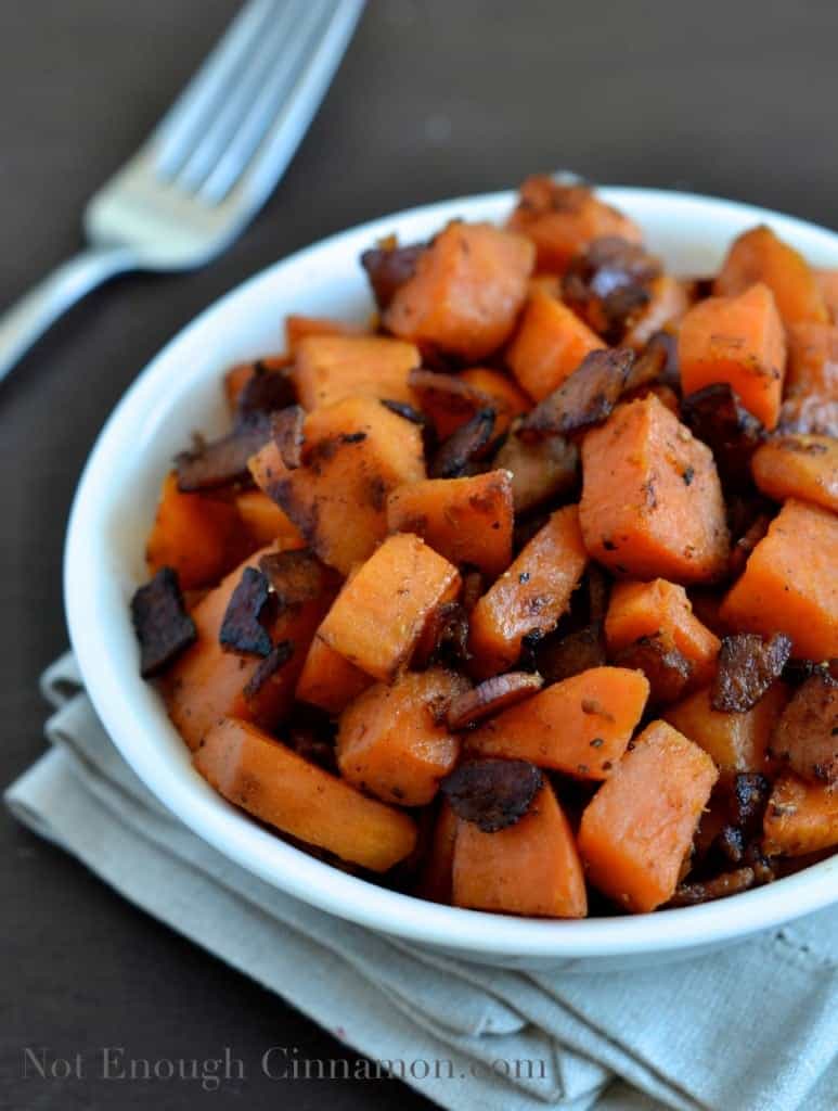 Bacon and Sweet Potato Skillet served in a small white bowl with a lot of crunchy bacon on top