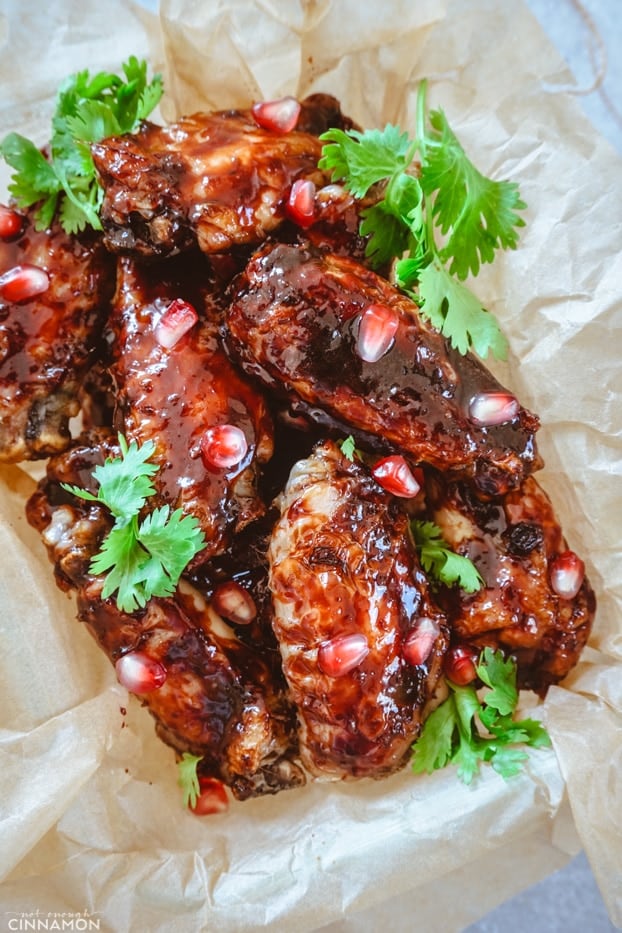 pomegranate glazed chicken wings with cilantro leaves and pomegranate arils