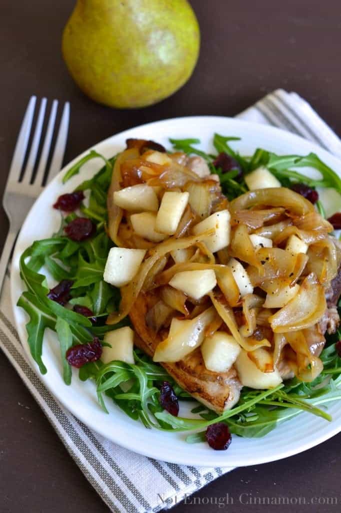 Pan-Seared Pork Chops topped with Pears and Caramelized Onions , served on a bed of arugula
