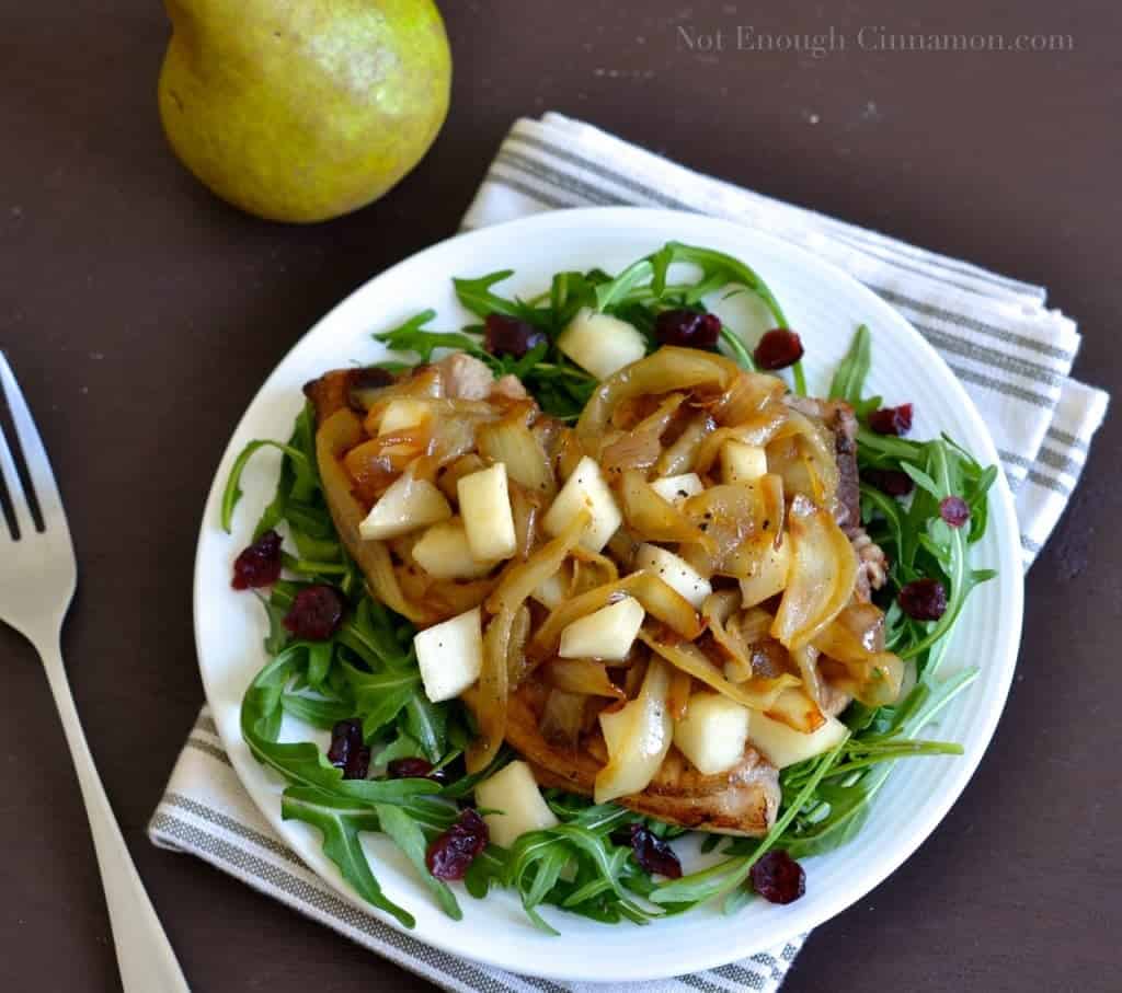 Pan-Seared Pork Chops topped with Pears and Caramelized Onions , served on a bed of arugula