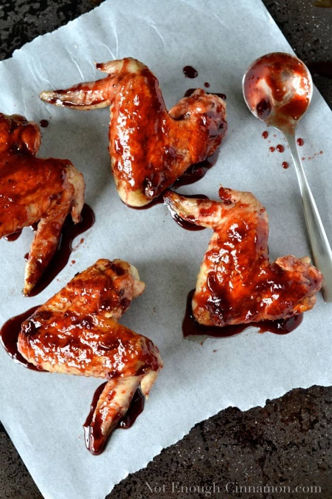 Pomegranate-Glazed Chicken Wings on a piece of parchment paper