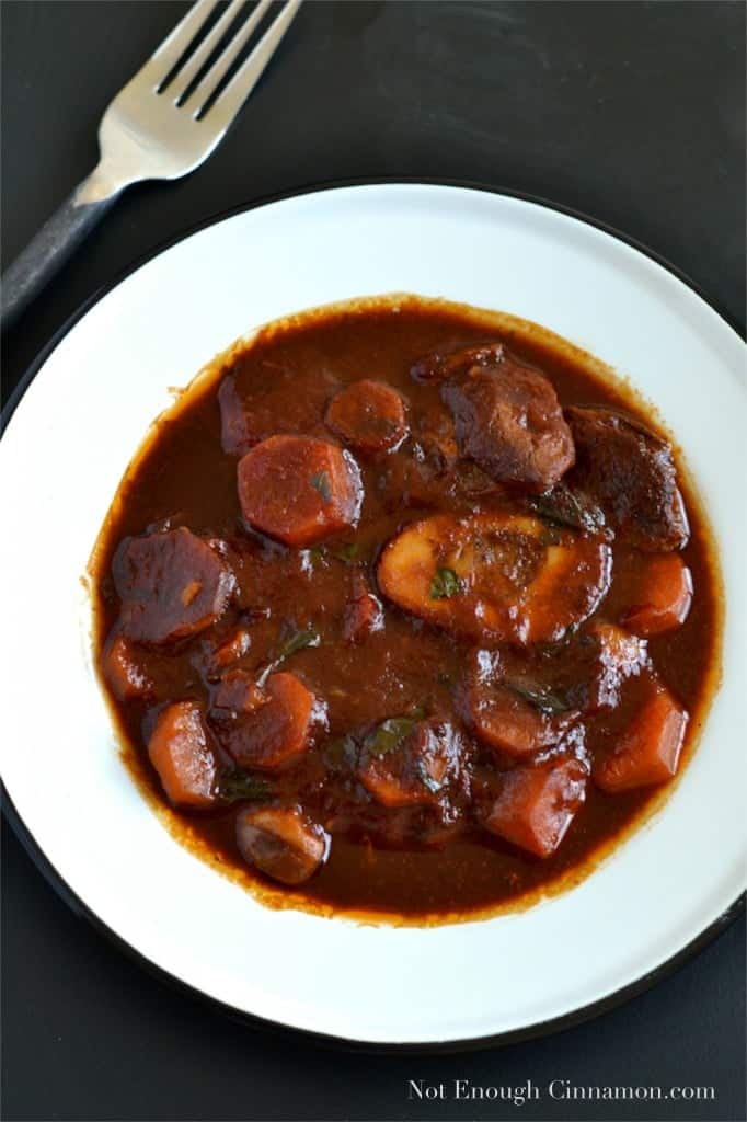 overhead shot of Slow-Cooker Beef Osso Bucco served in a white bowl with a fork on the side