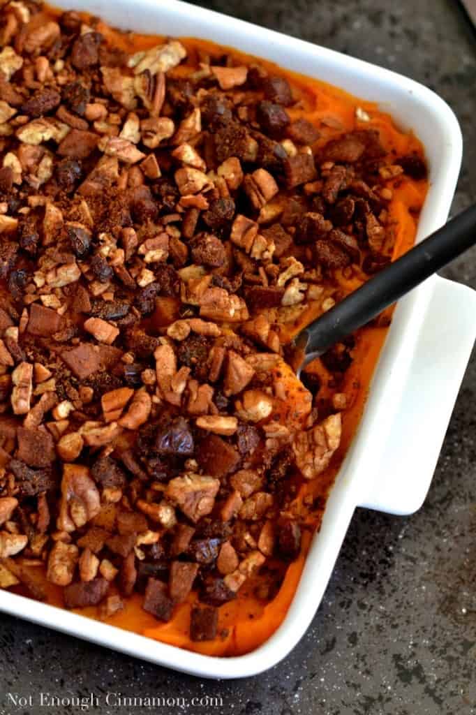 Sweet Potato Casserole with Pecans, Cranberries and Bacon on top served in a white casserole