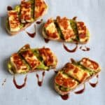 Grilled Halloumi, Avocado and Pomegranate Molasses Tartine served on parchment paper