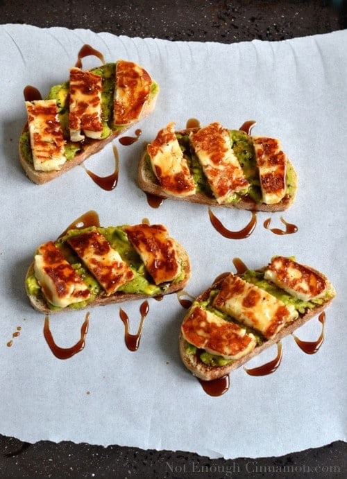 Grilled Halloumi, Avocado and Pomegranate Molasses Tartine served on parchment paper
