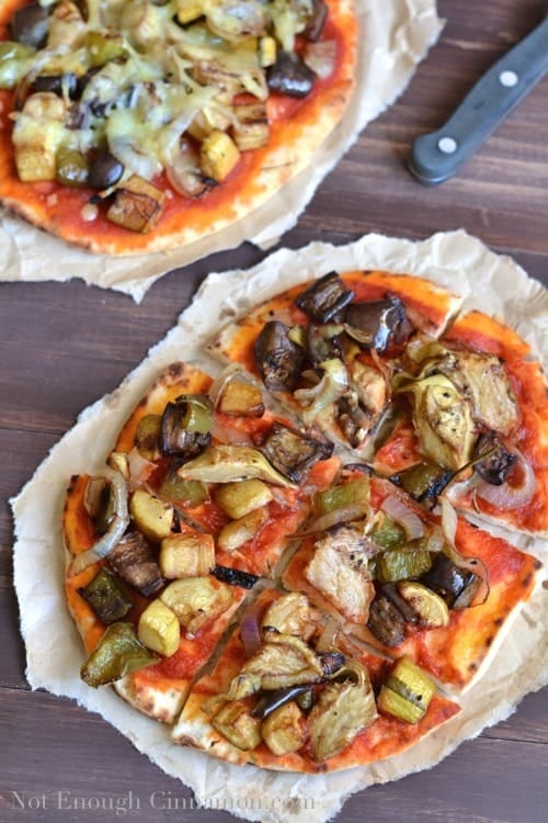 Gourmet Roasted Vegetable Pizza cut into 6 squares and served on a crinkled piece of parchment paper