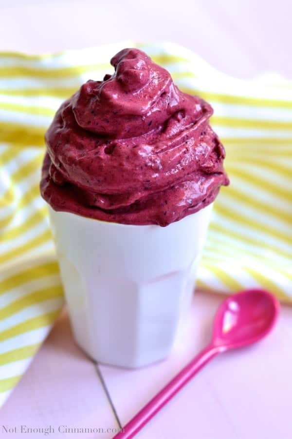 a big swirl of Sugar-free Very Berry Ice Cream served in a white cup with a pink spoon on the side