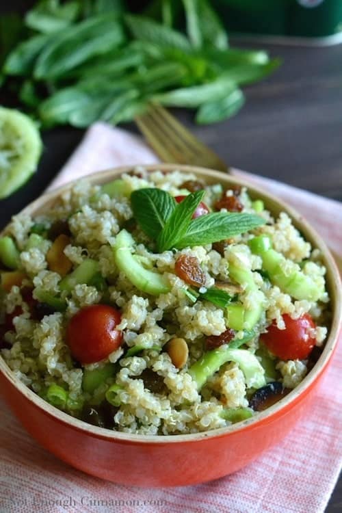 close-up of a red bowl with easy quinoa salad with tomatoes, cucumbers and mint
