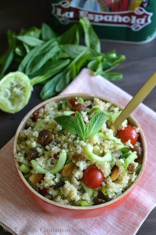 a red bowl of Gordon Ramsay's easy Quinoa Salad with tomatoes, mint and cucumber