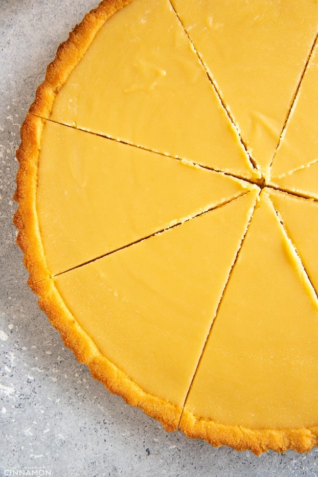 Close up on a sliced paleo lemon curd tart