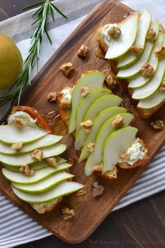 overhead shot of Pear and Gorgonzola Brioche Toast on a wooden chopping board drizzled with honey and sprinkled with chopped walnuts - toast recipe