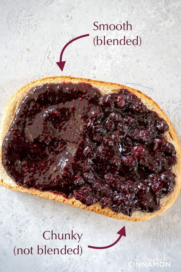 A toast of blueberry chia seed jam showing on side of chunky jam and one side of smooth jam.