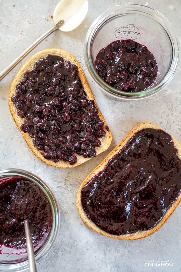 Bread toasts with blueberry chia seed jam, and two containers of jam