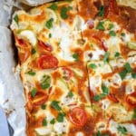 Baked Frittata in a metal square pan lined with parchment paper.