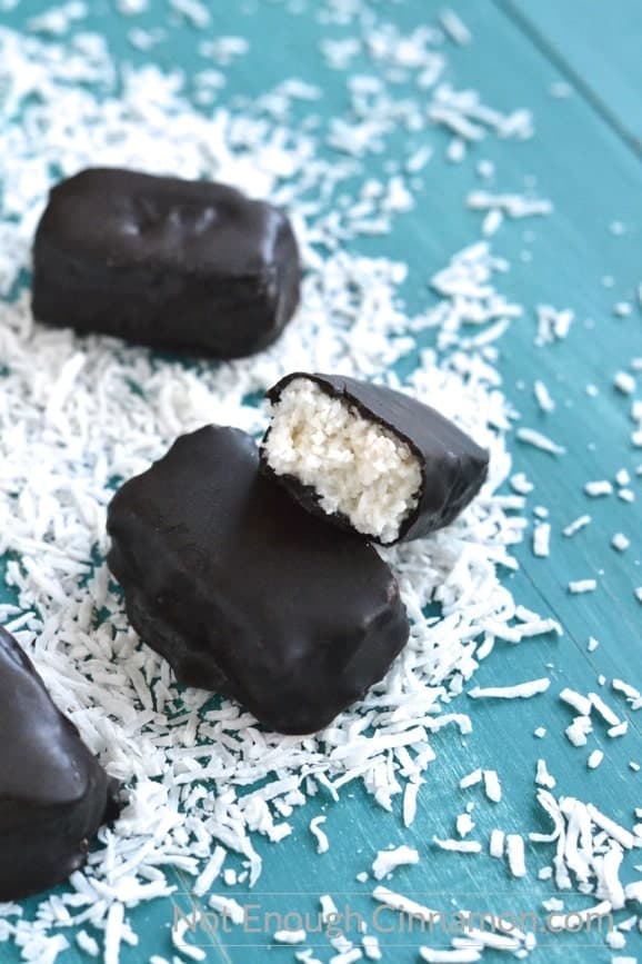 half a homemade paleo bounty bar stacked on top of another one to reveal the coconutty inside