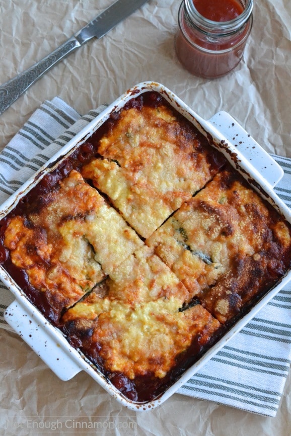 healthy vegetarian eggplant casserole in a rustic casserole dish cut into four squares 