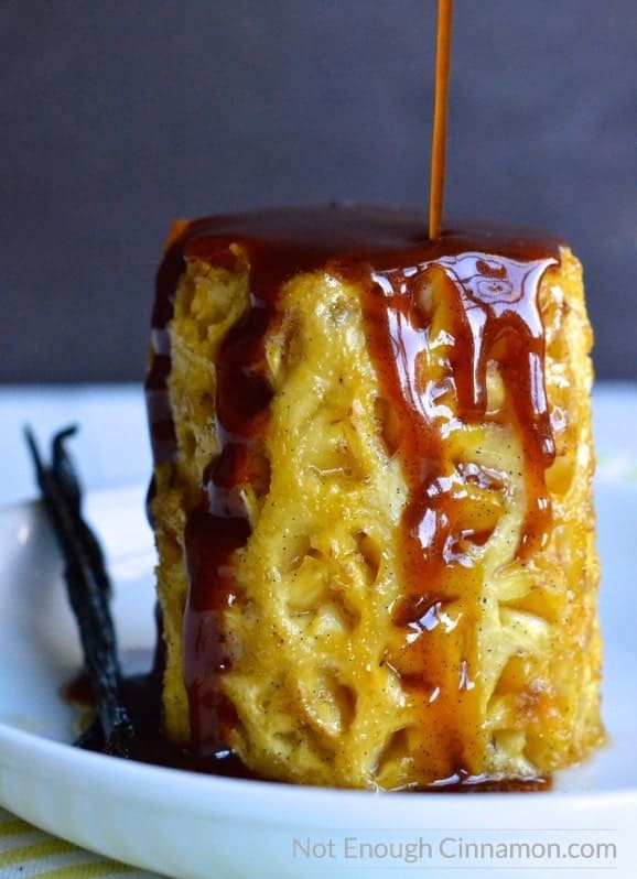 whole honey roasted pineapple on a plate being drizzled with sugar-free honey butter caramel sauce