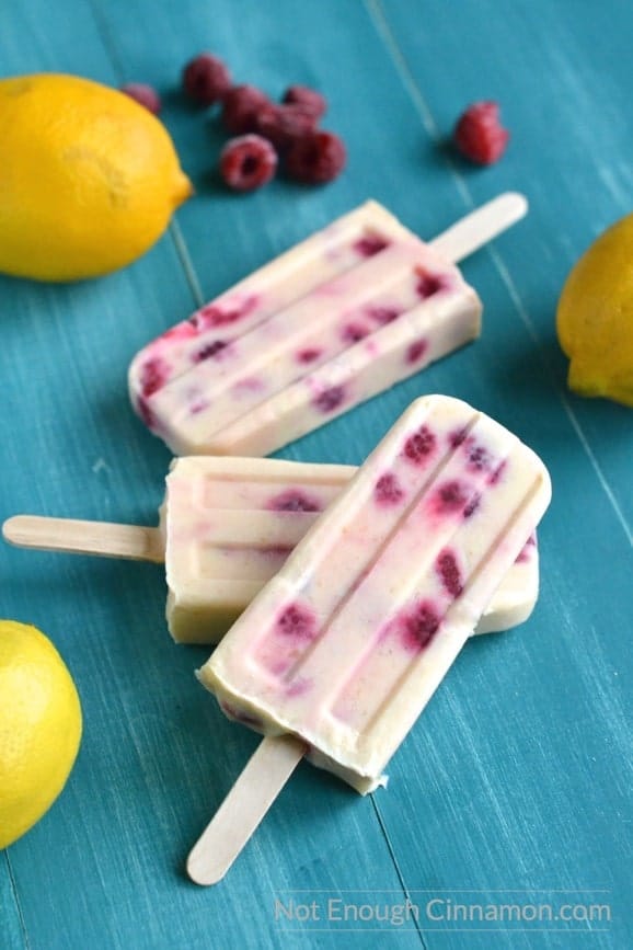 Skinny Lemon Curd and Raspberry Popsicles. Creamy, sweet and tangy at the same time. Made without refined sugar! - find the recipe on NotEnoughCinnamon.com