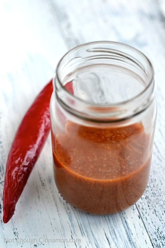 Thai Sweet Chili Sauce Dressing in a mason jar with a red chili on the side