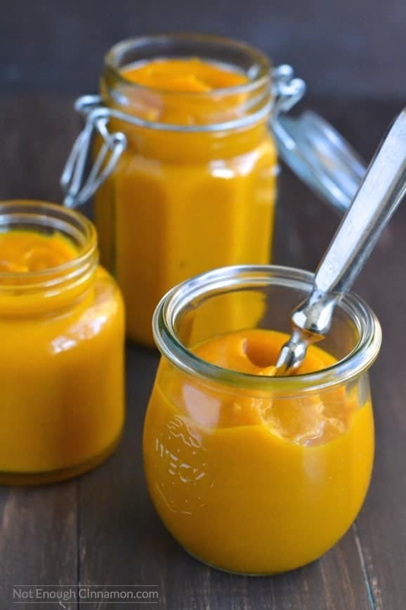 side view of homemade pumpkin puree in three mason jars 