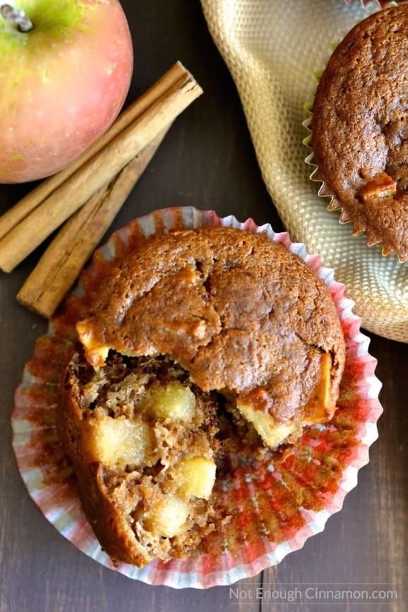 close-up of a healthy gluten-free apple spice muffin with a broken off to reveal the juice apple chunks inside