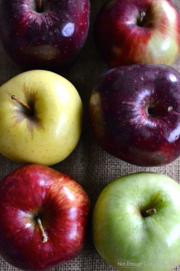 different colored apples on a piece of cloth 