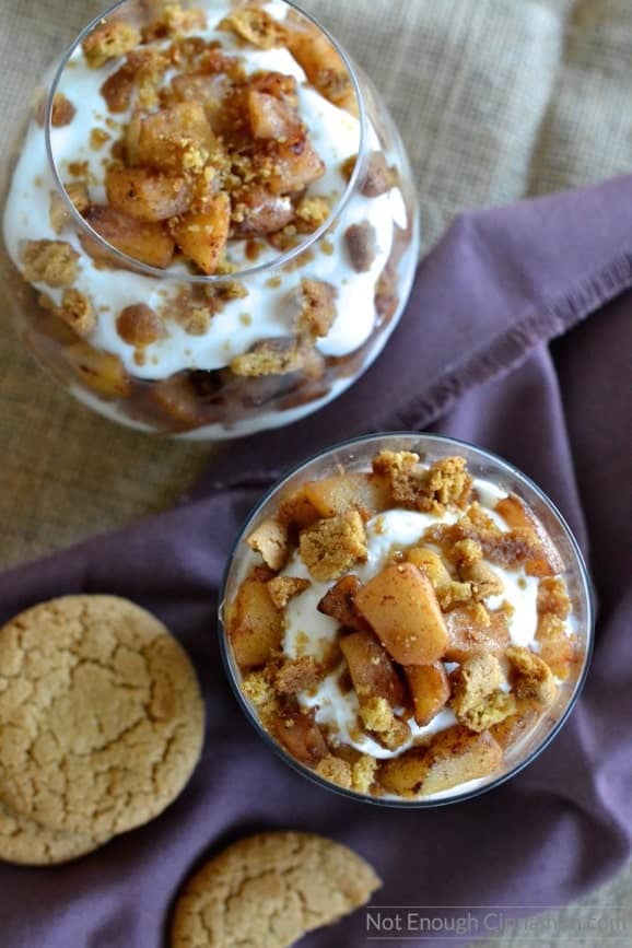 overhead shot of layered gingersnap and sauteed apples Greek yogurt parfaits with a gingersnap cookie on the side 