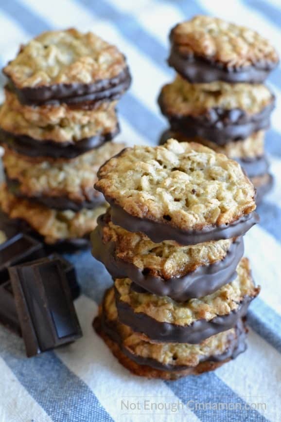 Ikea Crispy Oatmeal Cookies with chocolate stacked on top of each other on a striped tablecloth