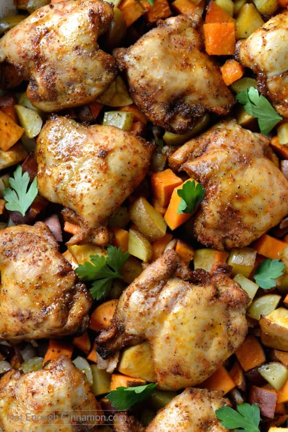 Close-up of a sheet pan with One Pan Chicken Dinner with BBQ spice rub and roasted chunks of apples and sweet potatoes 