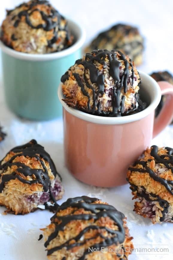 Refined sugar free, gluten free raspberry, chocolate coconut macaroons arranged in two pastel coloured espresso cups 