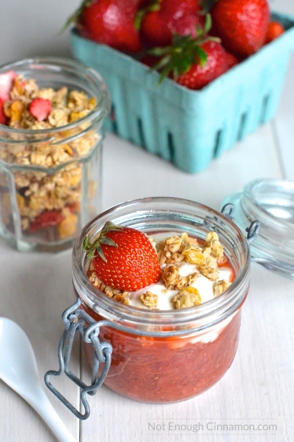 side view of rhubarb and strawberry chia pudding topped with granola and greek yogurt