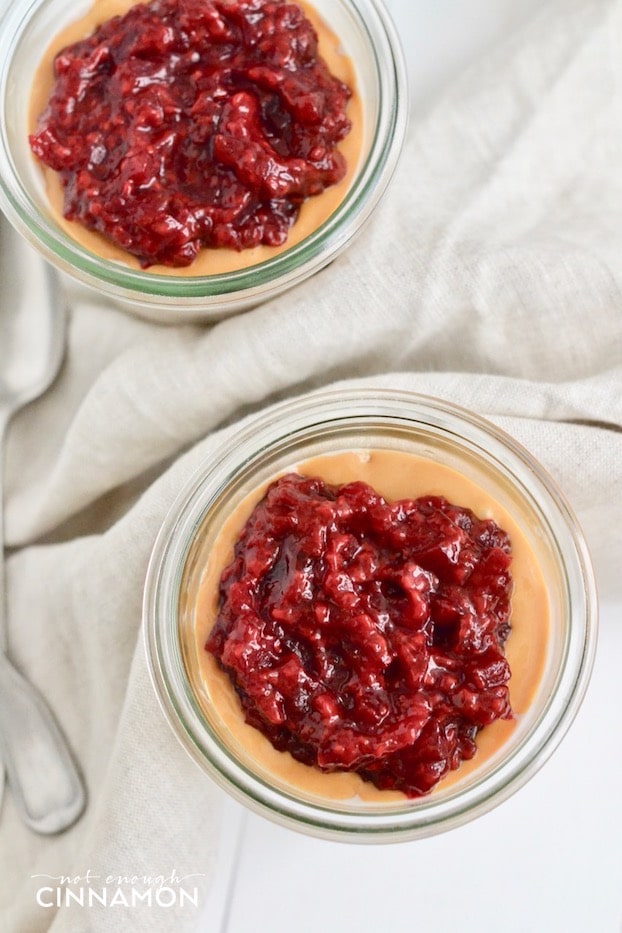 overhead shot of healthy peanut butter overnight oats topped with homemade quick raspberry jam