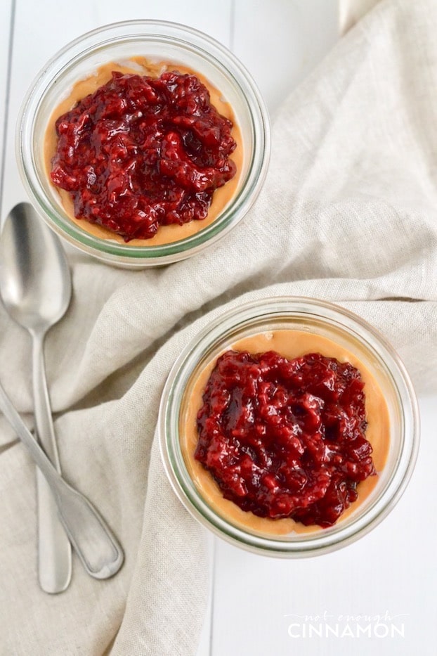 Peanut Butter and Jelly Overnight Oats with homemade raspberry jam served in two mason jars