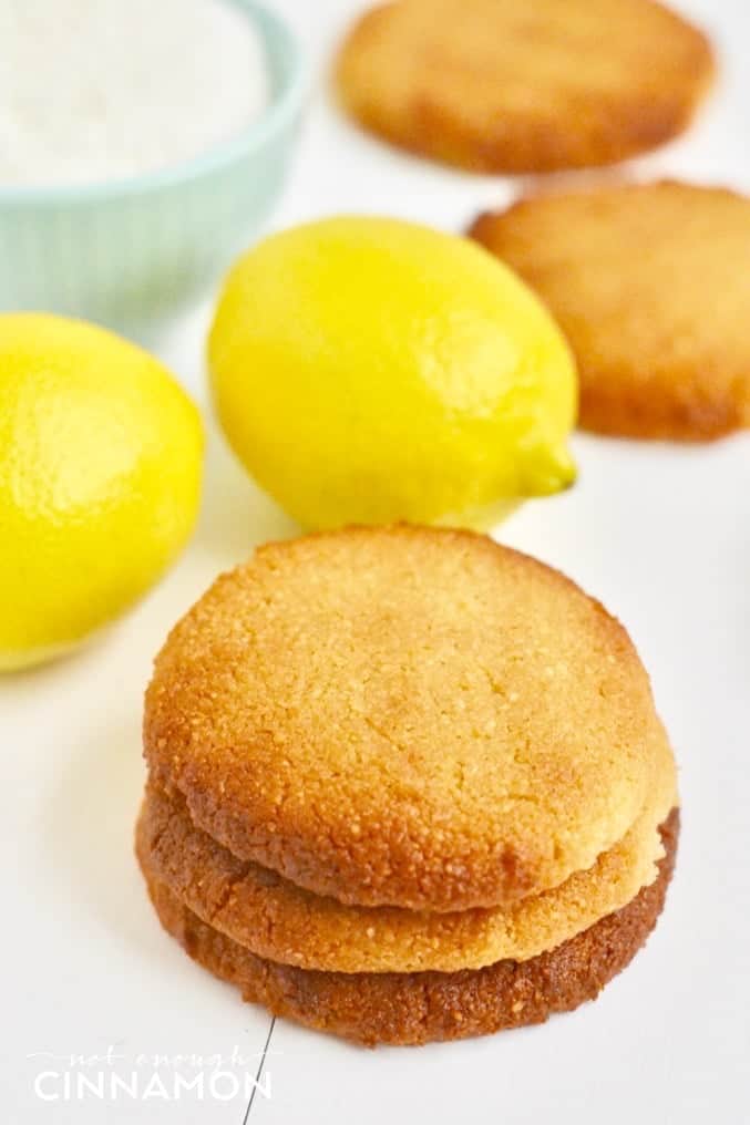Soft vegan coconut cookies with lemon stacked on top of each other