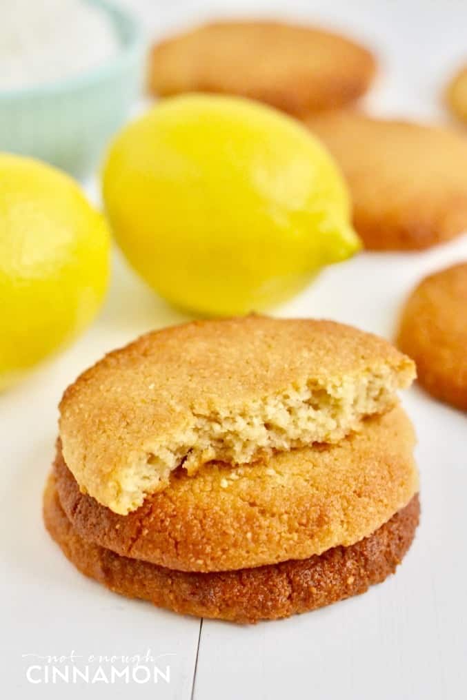 soft vegan coconut cookies with lemon stacked on top of each other