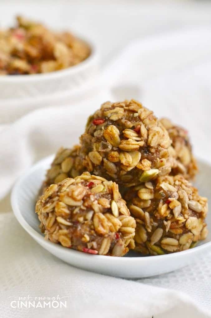 side view of Healthy No Bake Granola Bites stacked onto a small white saucer