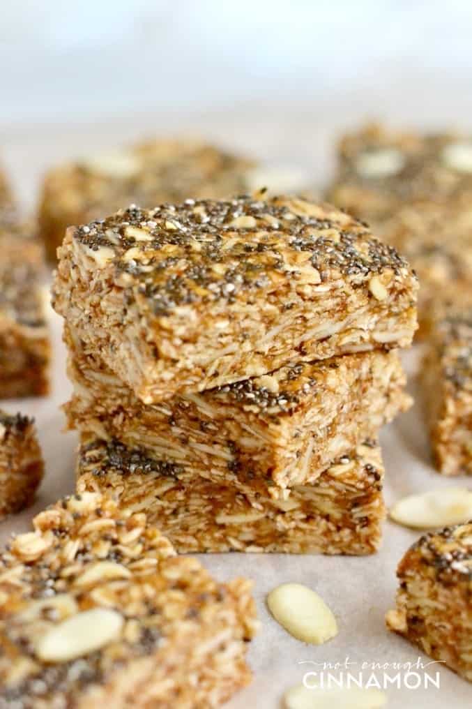 side view of a stack of no bake oatmeal bars with chia seeds, almonds and honey